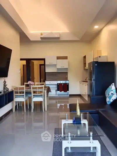 Modern open-plan living room and kitchen with sleek furniture and appliances.