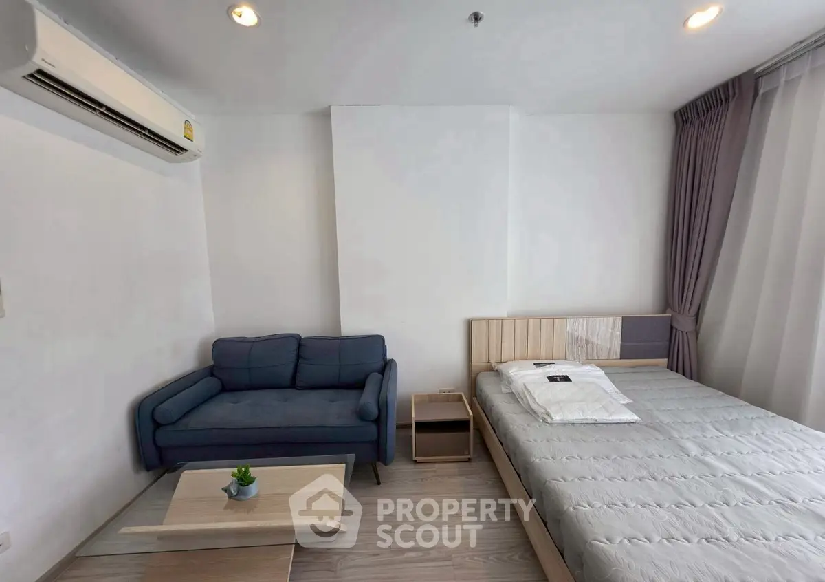 Modern bedroom with cozy sofa and stylish decor