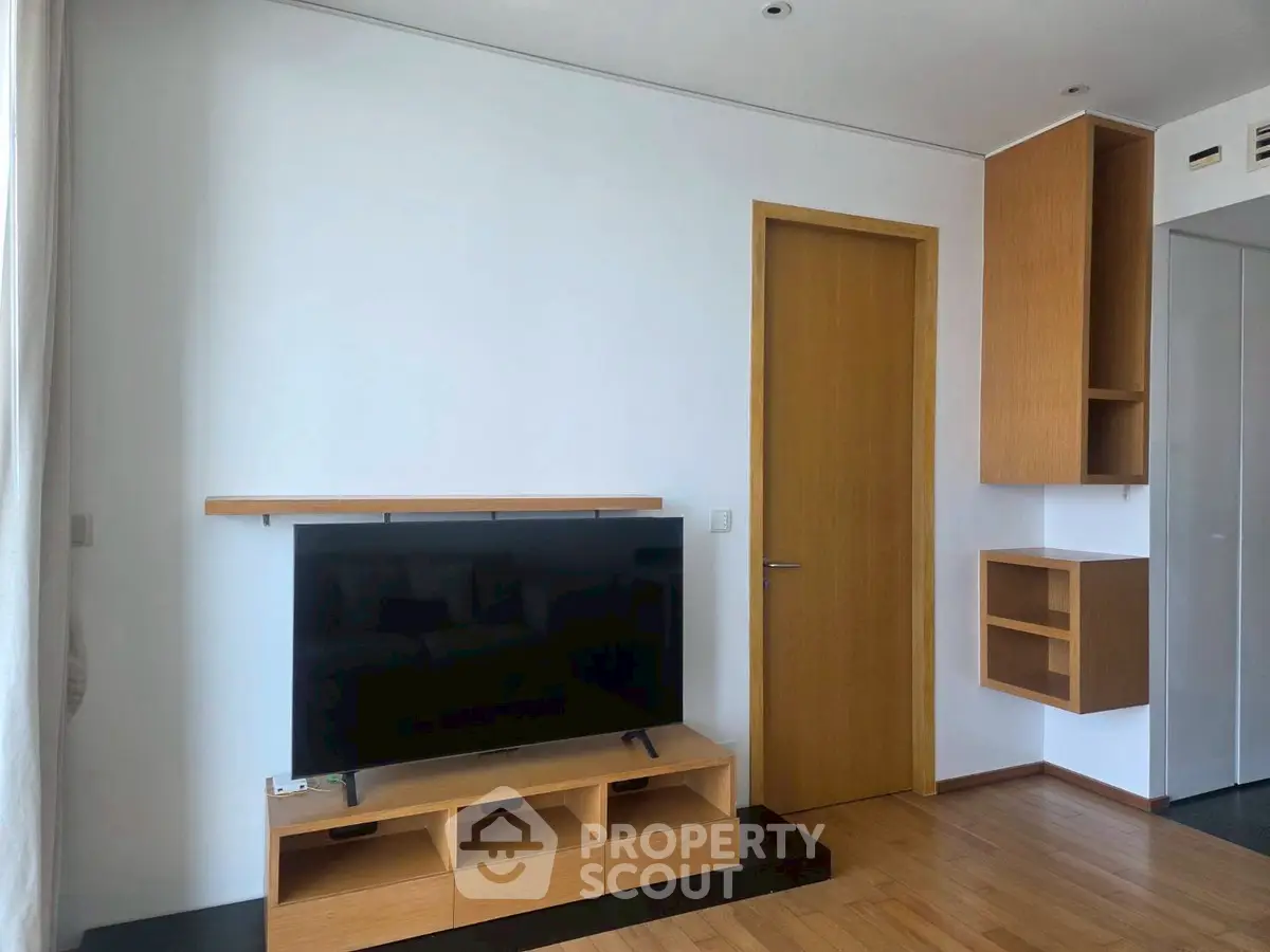 Modern living room with sleek wooden TV stand and minimalist design