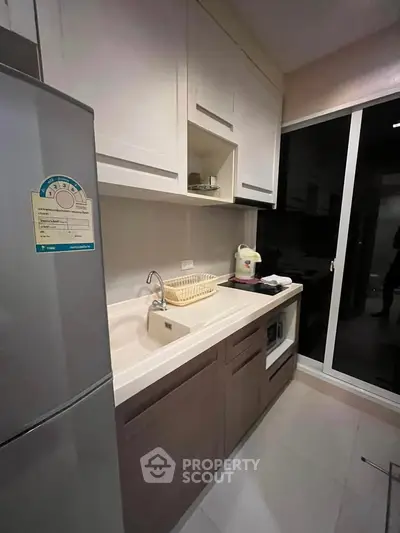 Modern kitchen with sleek cabinetry and appliances, featuring a spacious countertop and elegant design.