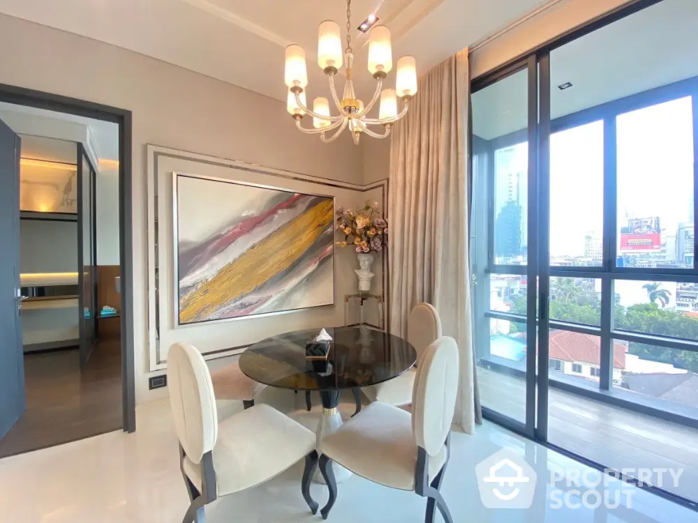 Elegant dining area with modern chandelier and city view balcony