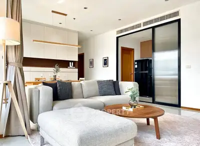 Modern living room with stylish furniture and open kitchen layout in a bright apartment.