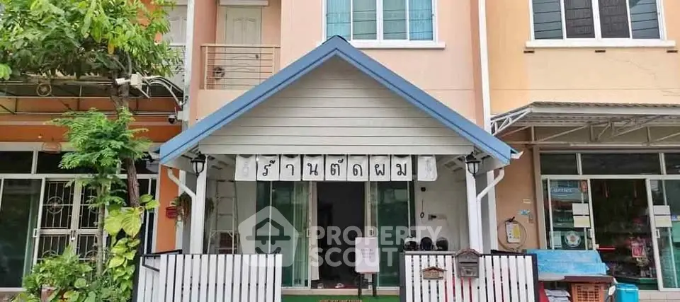 Charming townhouse with a welcoming entrance and lush greenery in a vibrant neighborhood.