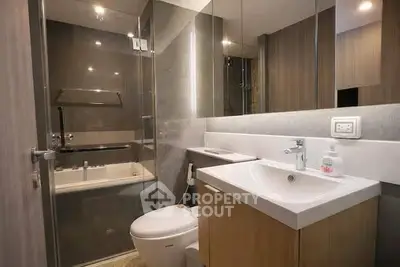 Modern bathroom with sleek fixtures and glass shower enclosure