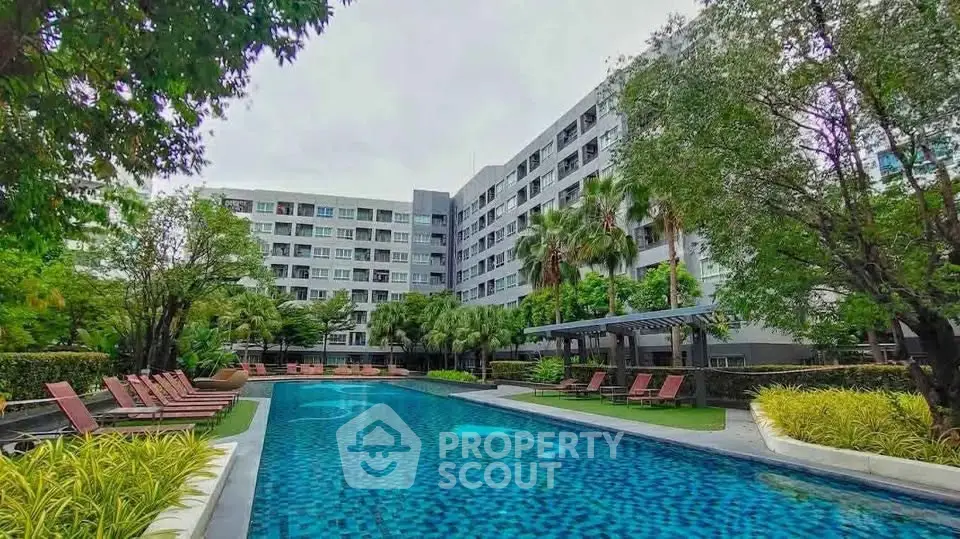 Luxurious apartment complex with a stunning outdoor pool and lush greenery, perfect for relaxation and leisure.