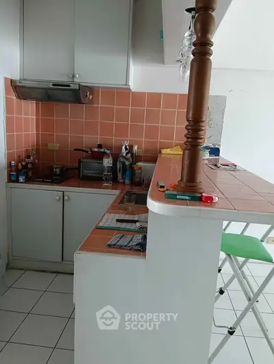 Charming kitchen with terracotta tiles and breakfast bar