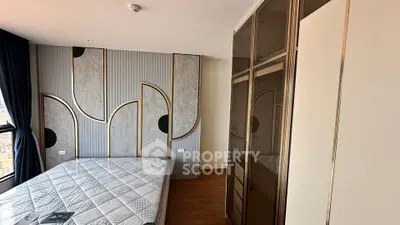 Modern bedroom with stylish wall design and large wardrobe in a high-rise apartment.