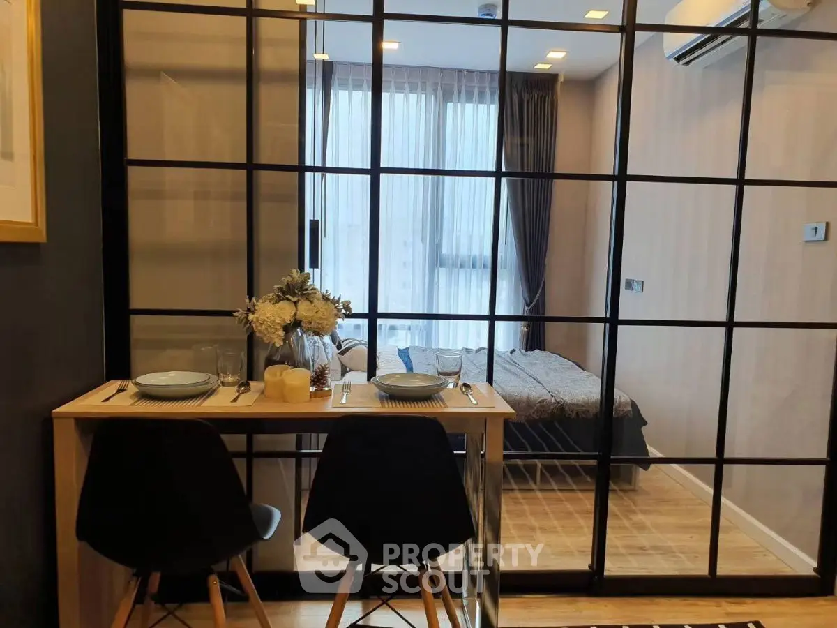 Modern studio apartment with glass partition and cozy dining area