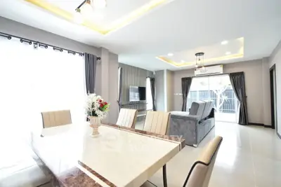 Spacious modern living room with elegant dining area and natural light