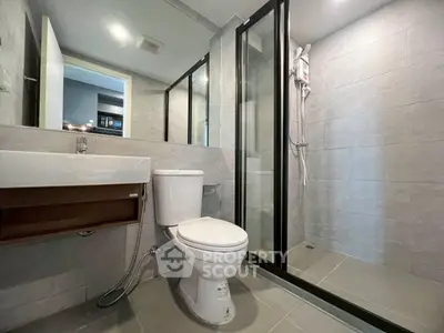 Modern bathroom with glass shower and sleek fixtures