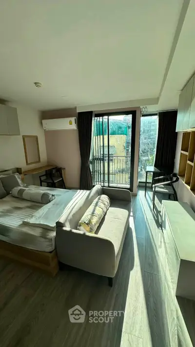 Modern bedroom with balcony and natural light in urban apartment