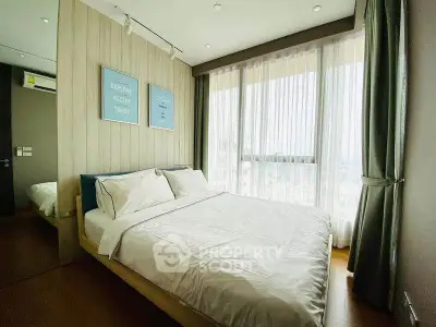 Modern bedroom with large windows and stylish decor in a high-rise apartment.