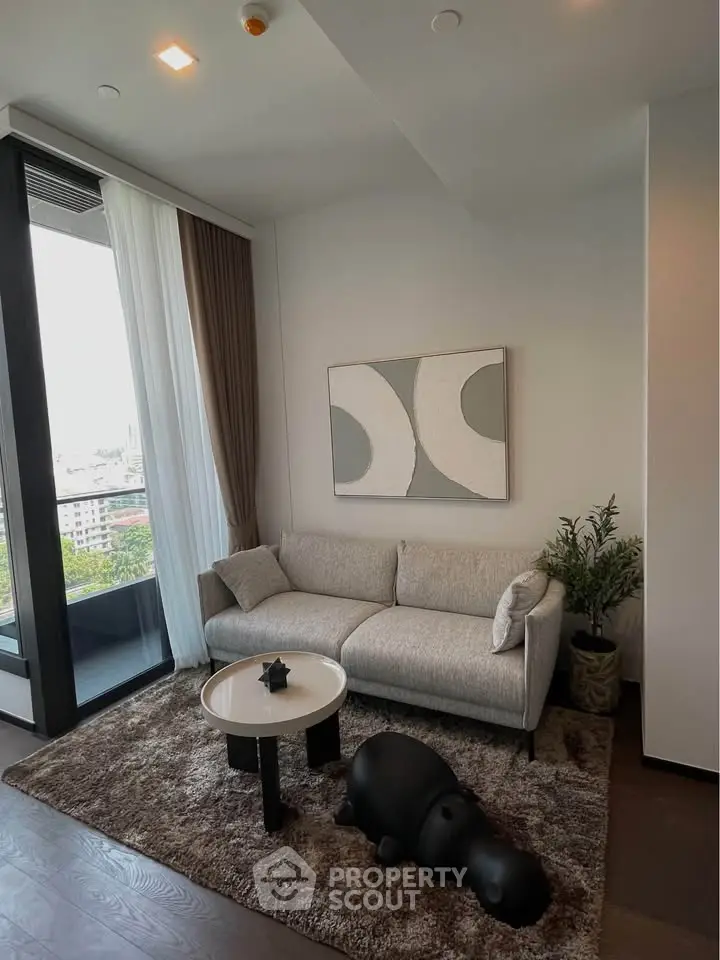 Stylish modern living room with cozy sofa, abstract art, and city view from large window.