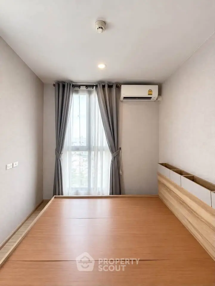 Modern minimalist bedroom with large window and air conditioning unit