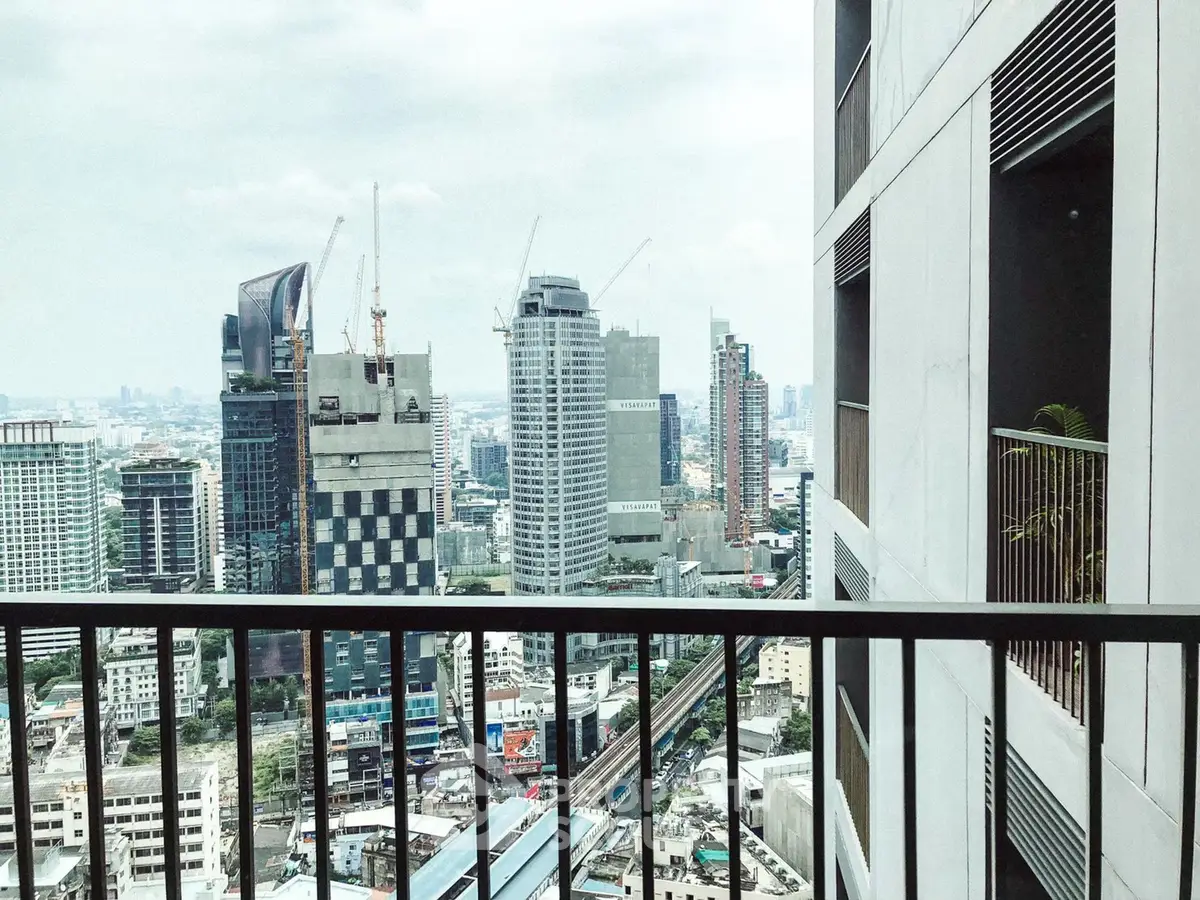 Stunning cityscape view from a high-rise balcony with modern architecture.