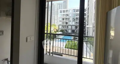 Modern apartment balcony with pool view and city skyline