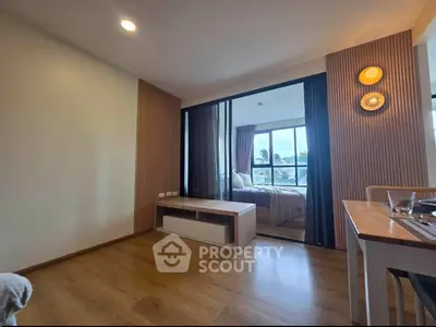 Modern apartment interior with wooden flooring and cozy bedroom view.