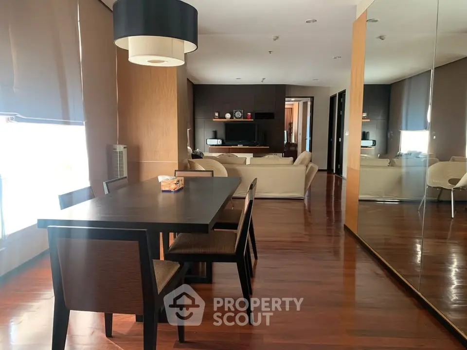 Spacious modern living room with elegant dining area and wooden flooring