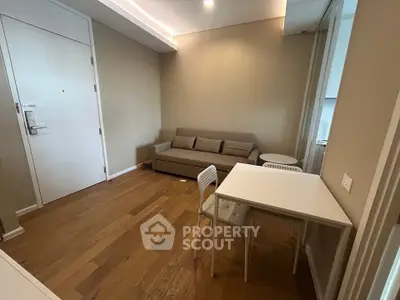 Cozy living room with modern furniture and wooden flooring in a stylish apartment.