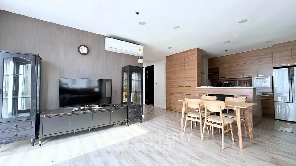Spacious modern living room with open kitchen and elegant wooden furniture