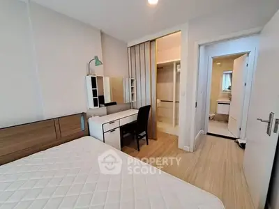 Modern bedroom with ensuite bathroom and stylish furniture in a contemporary apartment.