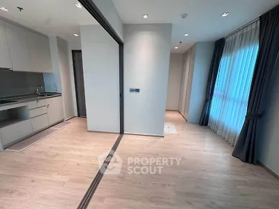 Modern apartment interior with sleek kitchen and large windows