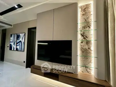 Modern living room with sleek TV unit and artistic wall decor