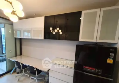 Modern kitchen with sleek cabinets and dining area in contemporary apartment