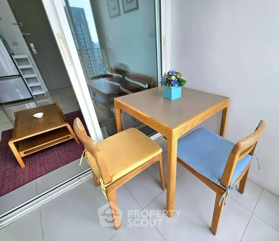 Charming balcony with cozy seating and city view, perfect for relaxation and enjoying the outdoors.