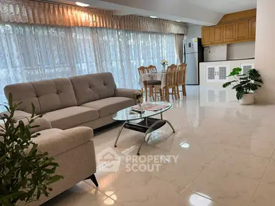Spacious open-plan living room with modern kitchen and elegant decor.
