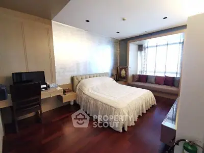 Spacious bedroom with elegant decor and cozy window seating