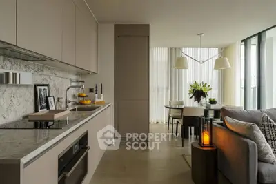 Modern open-layout kitchen and living room with elegant decor and natural light