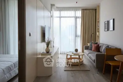 Modern living room with stylish decor and natural light in a cozy apartment setting.