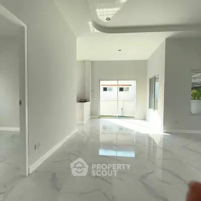 Spacious modern interior with marble flooring and abundant natural light