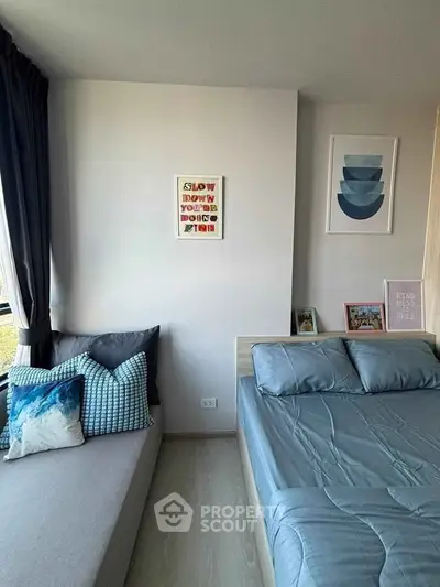 Modern bedroom with stylish decor and cozy seating area, perfect for relaxation and comfort.