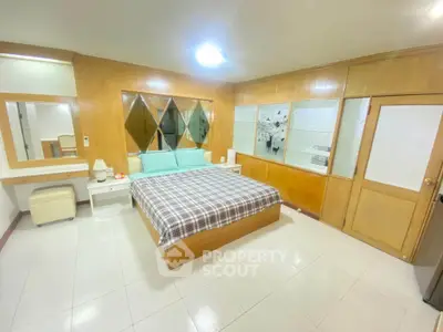 Spacious bedroom with modern decor and ample natural light