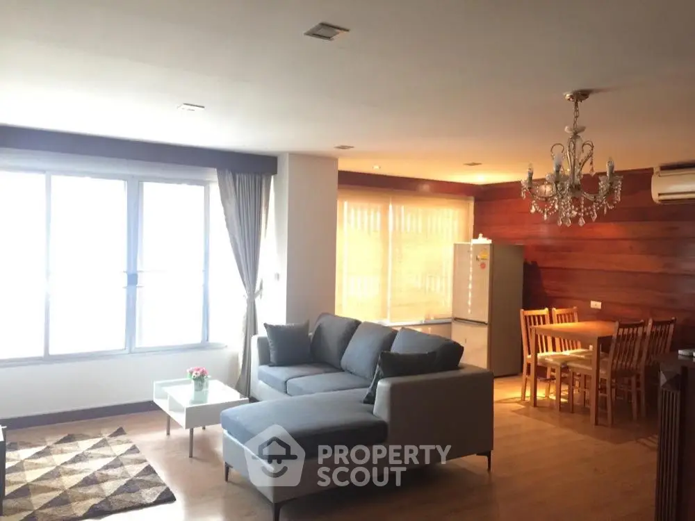 Spacious living room with elegant chandelier and modern furniture