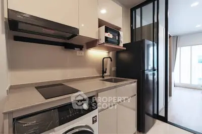 Modern kitchen with sleek appliances and open layout in stylish apartment