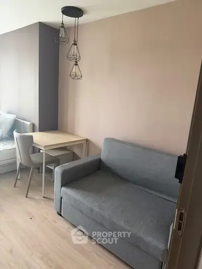 Modern living room with stylish sofa and dining area in a cozy apartment.