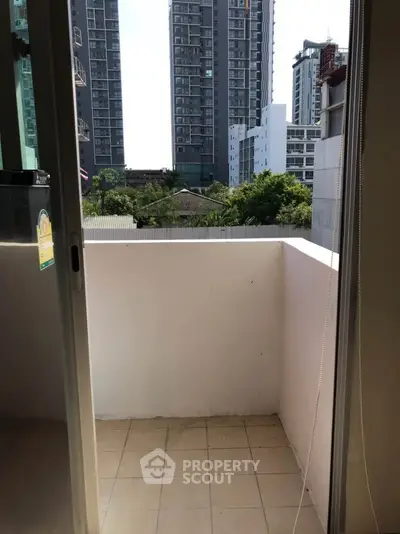 Cozy urban balcony with city view, perfect for relaxation and enjoying the skyline.