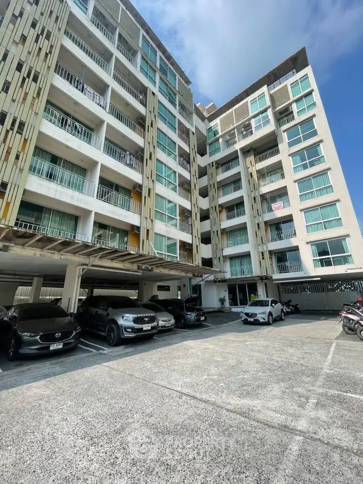 Modern apartment building with parking area and contemporary design.