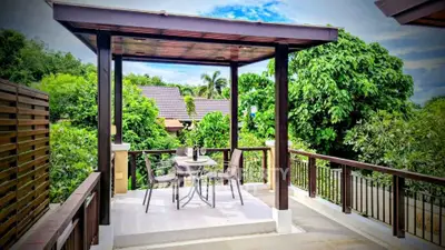 Charming outdoor terrace with lush greenery and stylish seating, perfect for relaxation and entertaining.