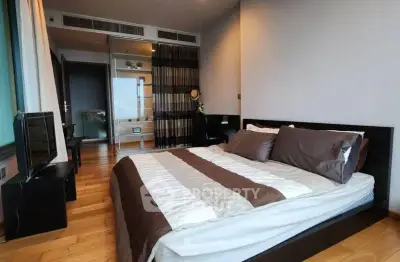 Modern bedroom with stylish decor and wooden flooring in a luxury apartment.