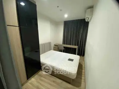 Modern bedroom with sleek design, featuring a comfortable bed, stylish wardrobe, and a cozy workspace.