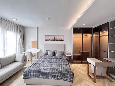 Modern bedroom with stylish decor and spacious layout, featuring a cozy bed and elegant furniture.