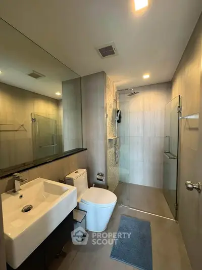 Modern bathroom with sleek fixtures and glass shower enclosure