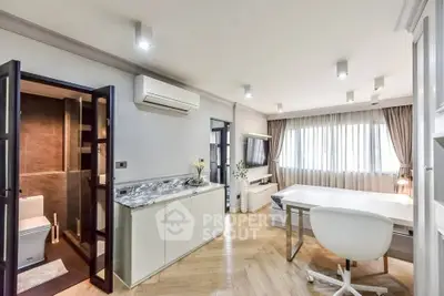 Modern living room with stylish decor and natural light, featuring a sleek workspace and elegant flooring.