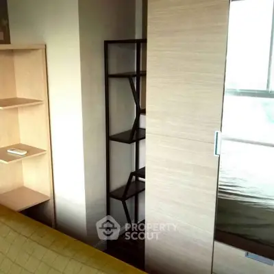 Modern bedroom with sleek shelving and sliding door design