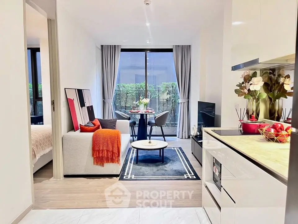 Modern open-plan living room with stylish decor and balcony view in a contemporary apartment.
