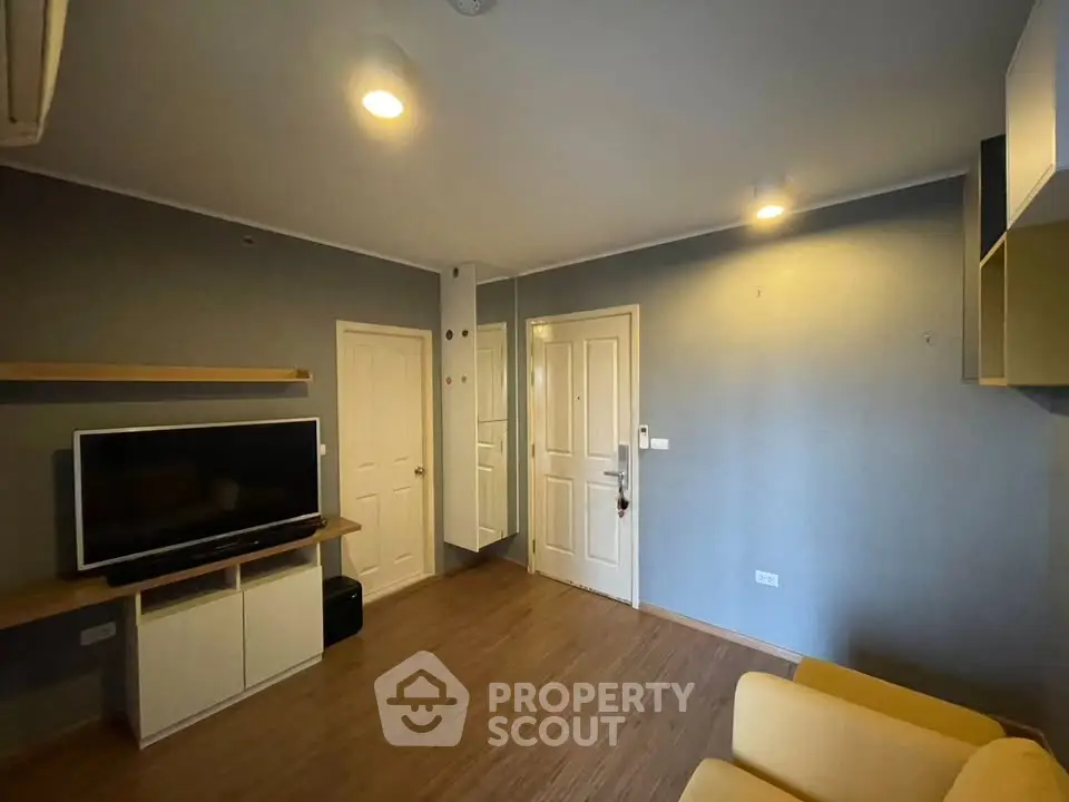 Modern living room with sleek TV setup and cozy seating area